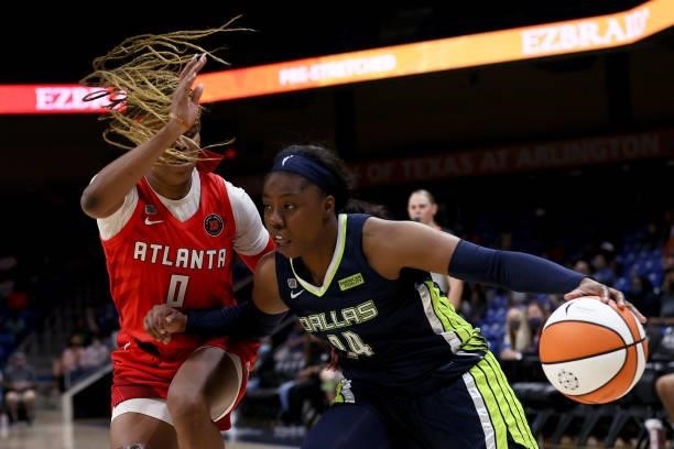 Guard Arike Ogunbowale of the Dallas Wings drives to the basket against guard Odyssey Sims of the Atlanta Dream in the second half at College Park...