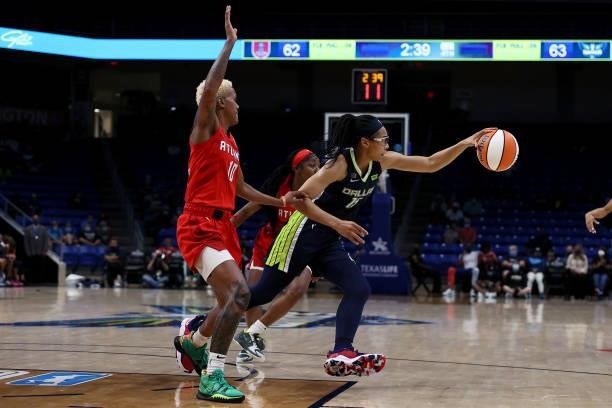 Guard Allisha Gray of the Dallas Wings drives to the basket against guard Courtney Williams of the Atlanta Dream in the second half at College Park...