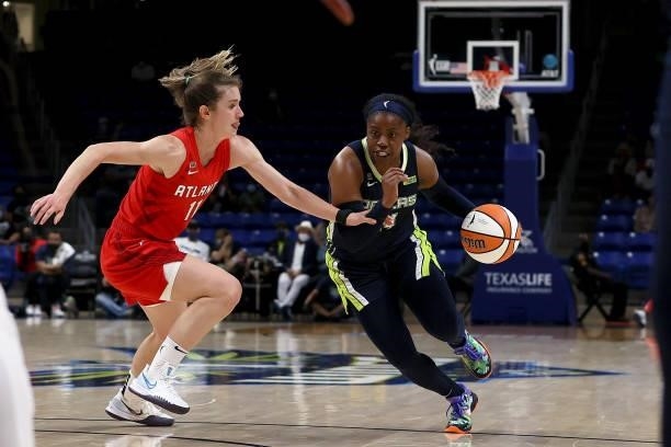 Guard Arike Ogunbowale of the Dallas Wings drives to the basket against Blake Dietrick of the Atlanta Dream in the second half at College Park Center...