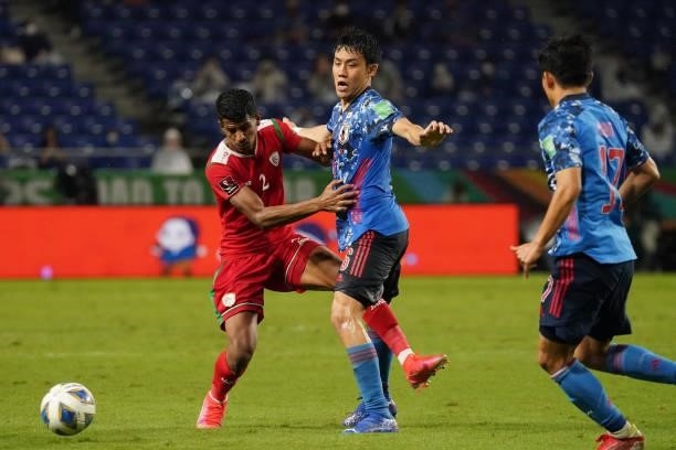 Wataru Endo of Japan and Issam Abdallah Al Sabhi of Oman compete for the ball during FIFA World Cup Asian Qualifier Final Round Group B match between...