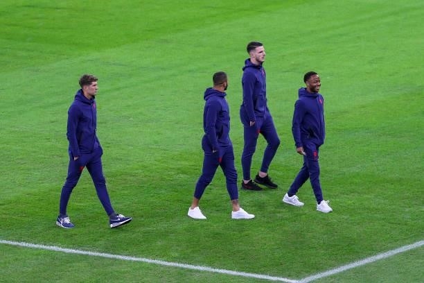 John Stones, Kyle Walker, Declan Rice and Raheem Sterling inspect the pitch before the 2022 FIFA World Cup Qualifiers match between Hungary and...