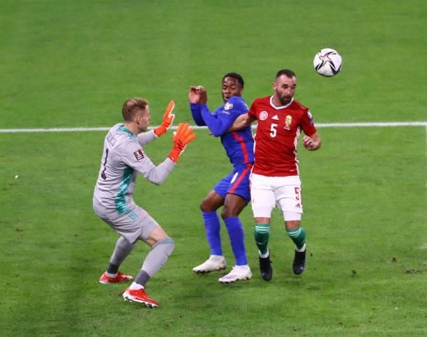 Attila Fiola of Hungary beats Raheem Sterling of England to the header during the 2022 FIFA World Cup Qualifiers match at Stadium Puskas Ferenc on...