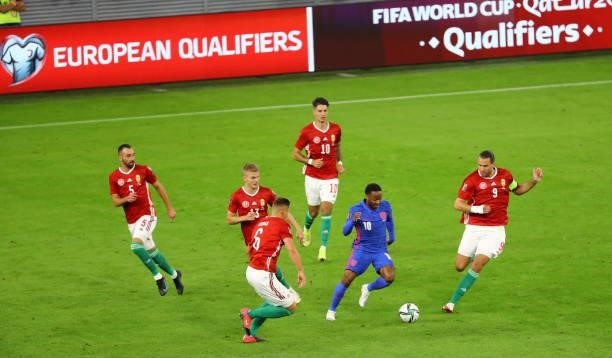 Raheem Sterling of England dribbles round the Hungary players during the 2022 FIFA World Cup Qualifiers match at Stadium Puskas Ferenc on September...