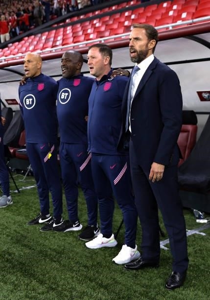 Paul Nevin, Chris Powell, Steve Holland assistant head coach and Gareth Southgate, England head coach take part in the national anthems prior to the...