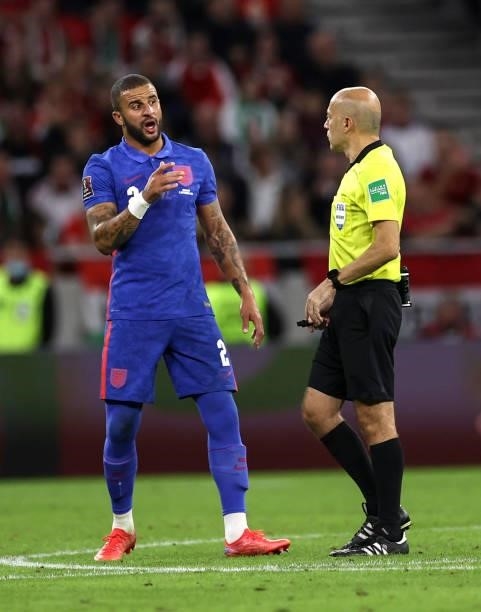 Kyle Walker of England talks to referee Cuneyt Cakır during the 2022 FIFA World Cup Qualifier match between Hungary and England at Stadium Puskas...