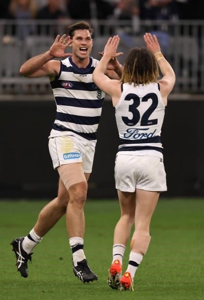 Tom Hawkins of the Cats is congratulated by Gryan Miers after kicking a goal during the AFL First Elimination Final match between Geelong Cats and...