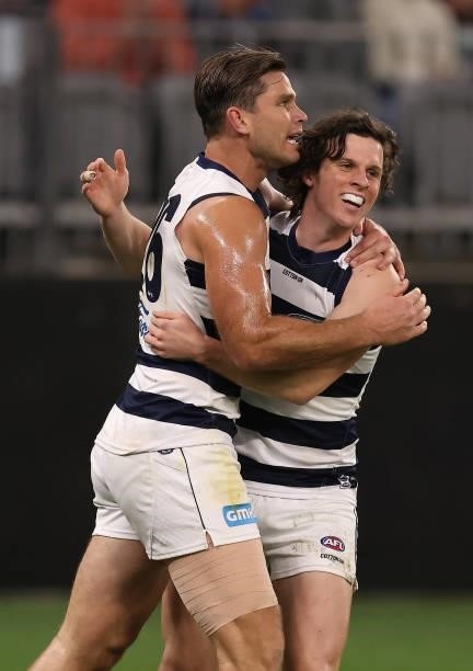 Tom Hawkins of the Cats is congratulated by Max Holmes after kicking a goal during the AFL First Elimination Final match between Geelong Cats and...
