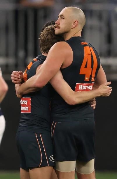 Shane Mumford of the Giants is hugged by team mates at the end of the match during the AFL First Elimination Final match between Geelong Cats and...
