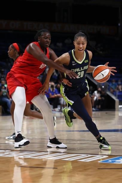 Forward Isabelle Harrison of the Dallas Wings drives to the basket against forward Shekinna Stricklen of the Atlanta Dream in the second half at...