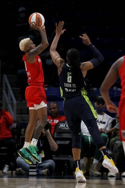 Guard Courtney Williams of the Atlanta Dream shoots the ball against forward Kayla Thornton of the Dallas Wings in the second half at College Park...
