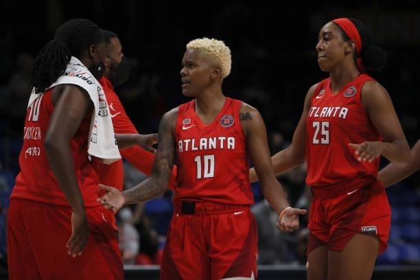 Guard Courtney Williams of the Atlanta Dream reacts with forward Shekinna Stricklen of the Atlanta Dream and forward Monique Billings of the Atlanta...