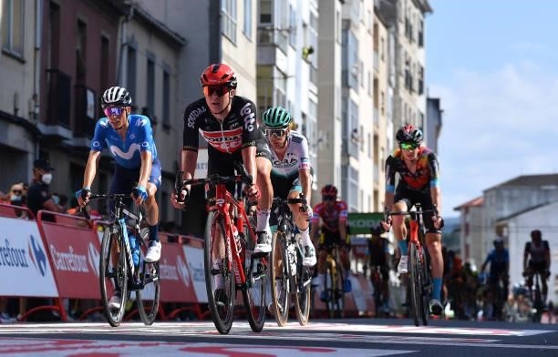 Enric Mas Nicolau of Spain and Movistar Team and Maxim Van Gils of Belgium and Team Lotto Soudal cross the finishing line during the 76th Tour of...