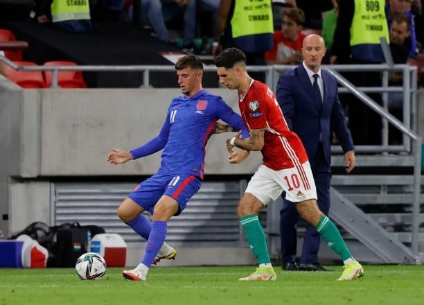 Mason Mount of England is challenged by Dominik Szoboszlai before Marco Rossi, manager of Hungary during the 2022 FIFA World Cup Qualifier match...