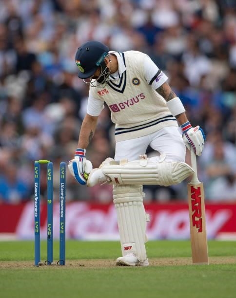 Indoa captain Virat Kohli uses a bail to remove soil from his spikes during the Fourth LV= Insurance Test Match: Day One between England and India at...