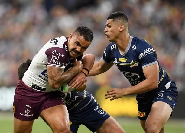 Dylan Walker of the Sea Eagles is tackled by Heilum Luki of the Cowboys during the round 25 NRL match between the North Queensland Cowboys and the...
