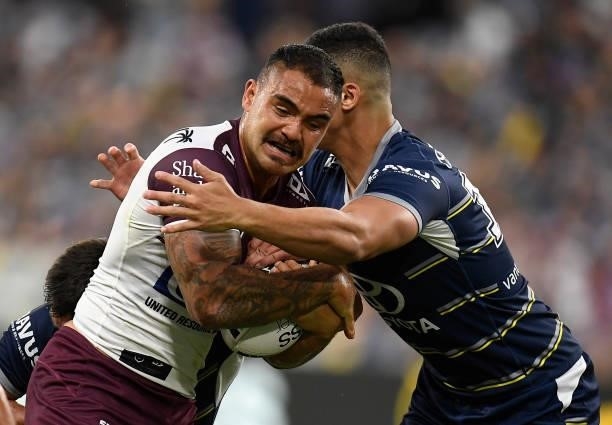 Dylan Walker of the Sea Eagles is tackled by Heilum Luki of the Cowboys during the round 25 NRL match between the North Queensland Cowboys and the...