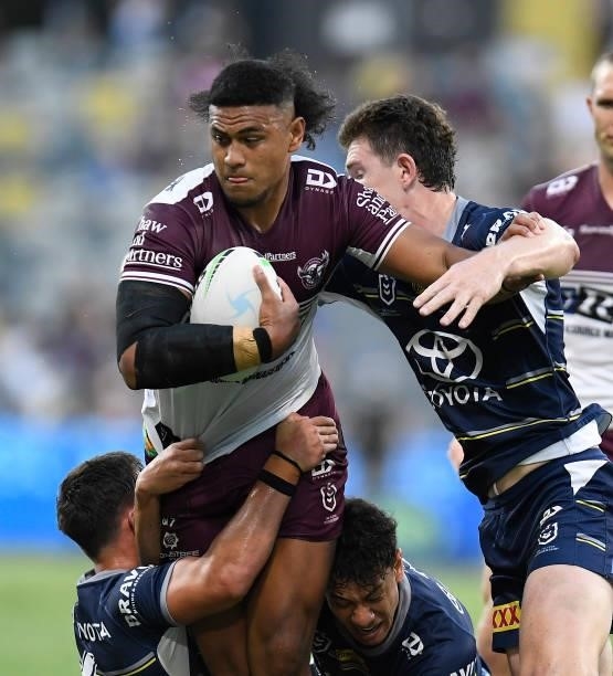Haumole Olakau'atu of the Sea Eagles is tackled during the round 25 NRL match between the North Queensland Cowboys and the Manly Sea Eagles at QCB...