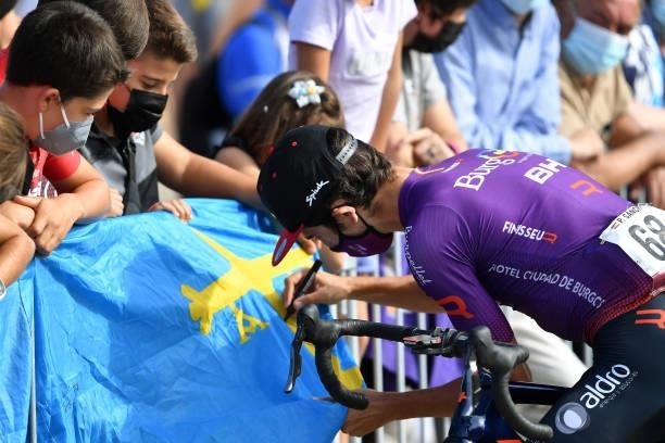 Pelayo Sanchez Mayo of Spain and Team Burgos - BH signs a flag to fans prior to the 76th Tour of Spain 2021, Stage 20 a 202,2km km stage from...