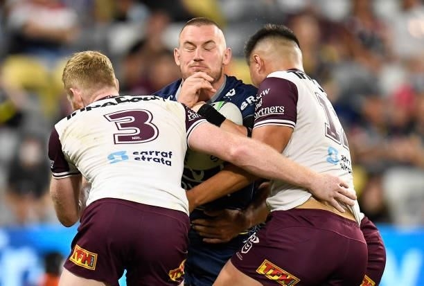 Coen Hess of the Cowboys is tackled during the round 25 NRL match between the North Queensland Cowboys and the Manly Sea Eagles at QCB Stadium, on...