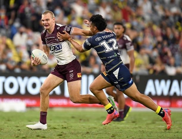 Tom Trbojevic of the Sea Eagles fends off Jeremiah Nanai of the Cowboys during the round 25 NRL match between the North Queensland Cowboys and the...