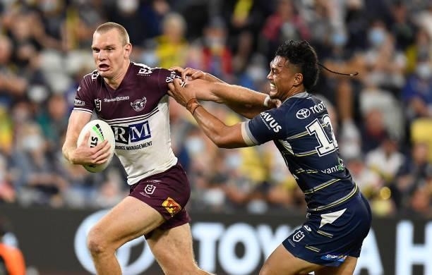 Tom Trbojevic of the Sea Eagles fends off Jeremiah Nanai of the Cowboys during the round 25 NRL match between the North Queensland Cowboys and the...