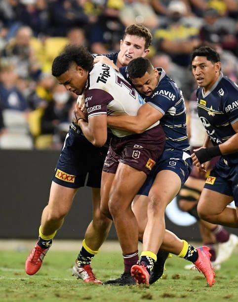 Haumole Olakau'atu of the Sea Eagles is tackled during the round 25 NRL match between the North Queensland Cowboys and the Manly Sea Eagles at QCB...