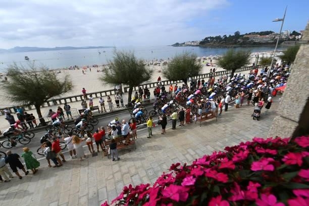 General view of the peloton passing through Sanxenxo village at start while fans cheer during the 76th Tour of Spain 2021, Stage 20 a 202,2km km...