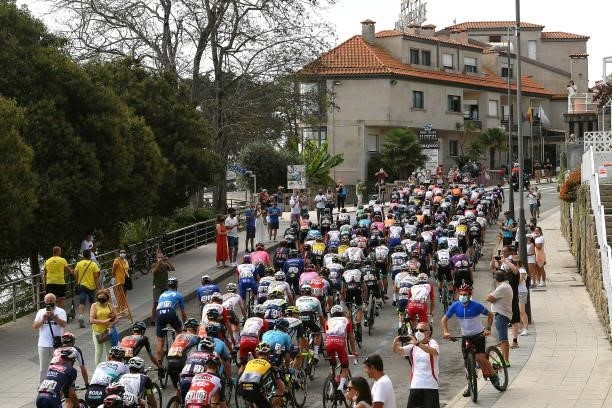 General view of the peloton passing through Sanxenxo village at start while fans cheer during the 76th Tour of Spain 2021, Stage 20 a 202,2km km...