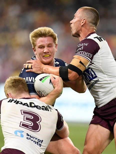Tom Dearden of the Cowboys is tackled by Brad Parker and Kieran Foran of the Sea Eagles during the round 25 NRL match between the North Queensland...