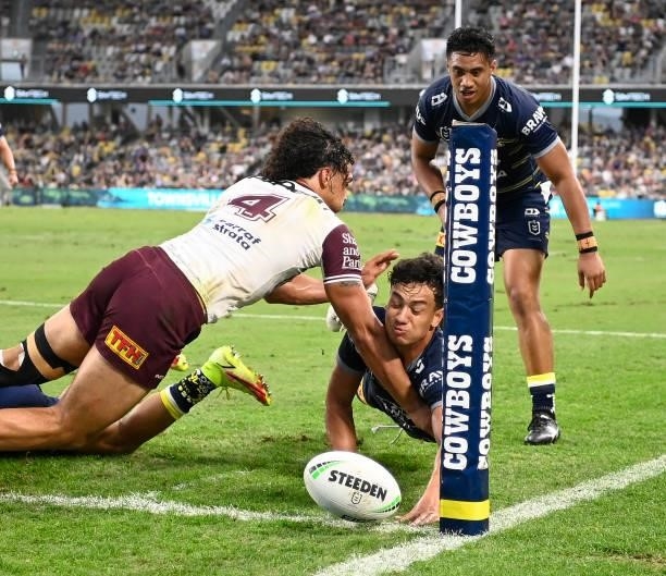 Daejarn Asi of the Cowboys dives for the try line during the round 25 NRL match between the North Queensland Cowboys and the Manly Sea Eagles at QCB...