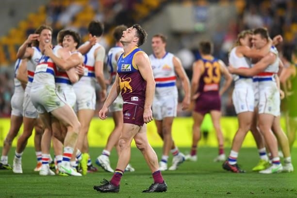 Lincoln McCarthy of the Lions looks dejected as Western Bulldogs celebrate during the AFL 1st Semi Final match between the Brisbane Lions and the...