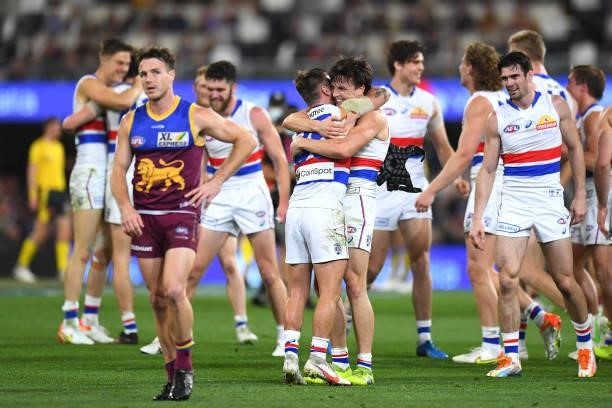 Caleb Daniel of the Bulldogs hugs team mate Laitham Vandermeer after their victory during the AFL 1st Semi Final match between the Brisbane Lions and...