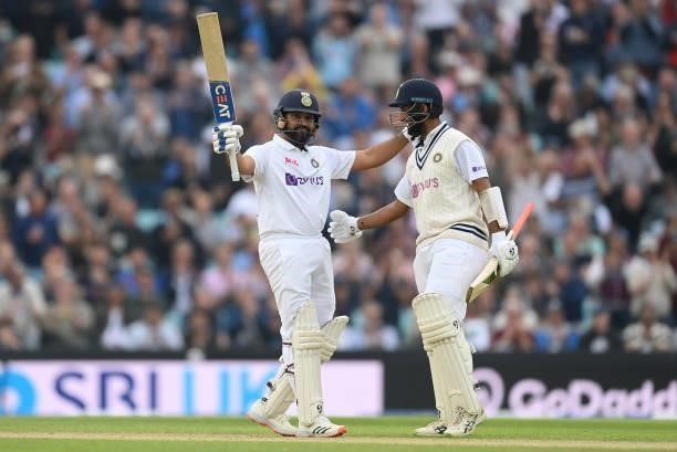 Rohit Sharma celebrates with Cheteshwar Pujara of India after reaching his century during the third day of the 4th LV= Test Match between England and...