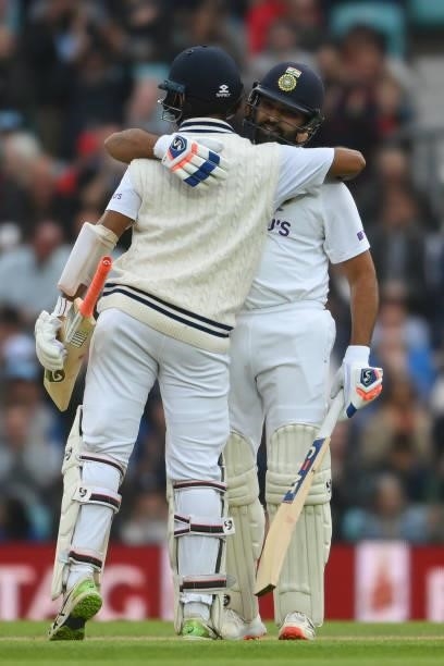 Rohit Sharma of India celebrates with Cheteshwar Pujara after reaching his century during the Fourth LV= Insurance Test Match: Day Three between...