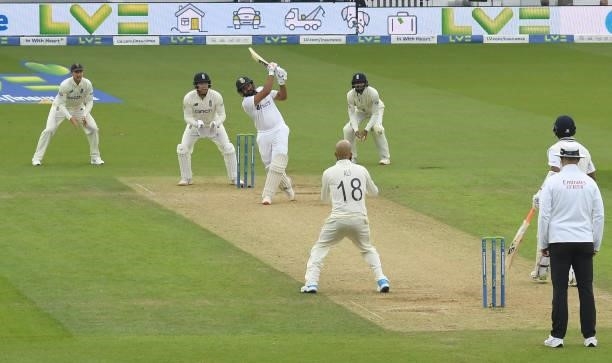 Rohit Sharma of India hits a six to complete his century as Joe Root, Jonny Bairstow and Haseeb Hameed of England look on during the third day of the...
