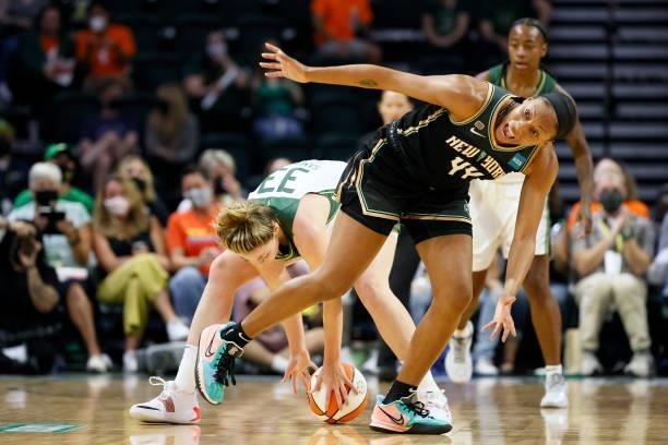 Katie Lou Samuelson of the Seattle Storm and Betnijah Laney of the New York Liberty battle for a loose ball during the first quarter at Angel of the...