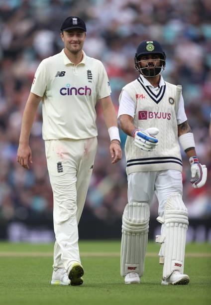 Ollie Robinson of England and Virat Kohli of India share a joke as they walk off for bad light during day three of the fourth LV= Insurance Test...