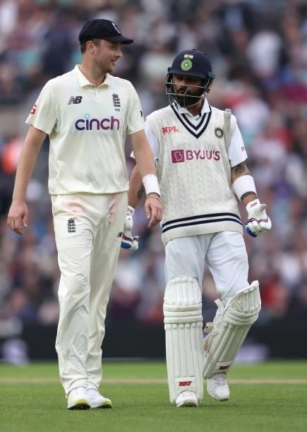 Ollie Robinson of England and Virat Kohli of India share a joke as they walk off for bad light during day three of the fourth LV= Insurance Test...