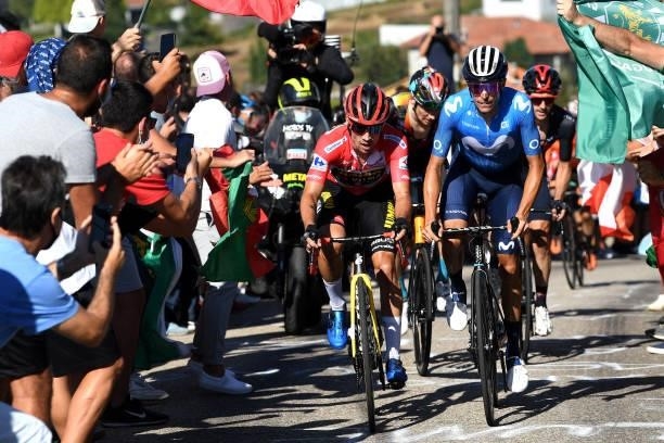 Primoz Roglic of Slovenia and Team Jumbo - Visma red leader jersey and Enric Mas Nicolau of Spain and Movistar Team attack in the breakaway while...