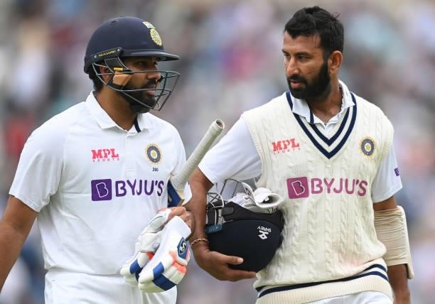 Rohit Sharma and Cheteshwar Pujara of India leave the field for the lunch break during the third day of the 4th LV= Test Match between England and...