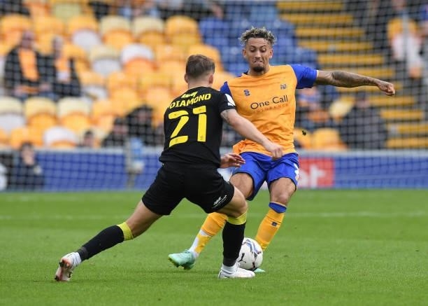 Kellan Gordon of Mansfield Town is challenged by Jack Diamond of Harrogate Town during the Sky Bet League Two match between Mansfield Town and...
