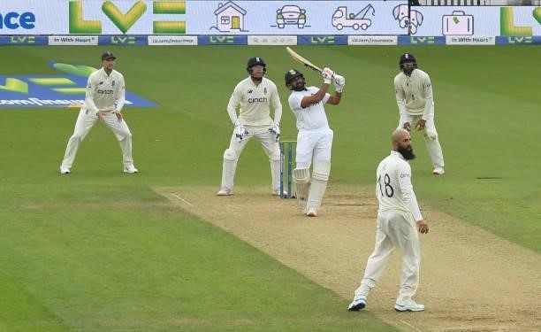 Rohit Sharma of India hits a six to complete his century as Joe Root, Jonny Bairstow, Moeen Ali and Haseeb Hameed of England look on during the third...