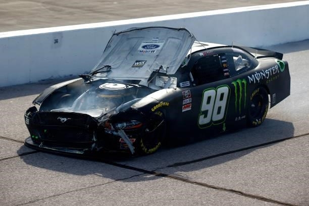 Riley Herbst, driver of the Monster Energy Ford, drives a damaged car onto pit road during the NASCAR Xfinity Series Sport Clips Haircuts VFW Help A...
