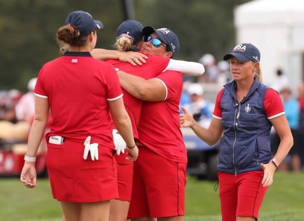 Captain Patty Hurst congratulates Nelly Korda of Team USA and Ally Ewing of Team USA after winning their match during the Foursomes Match on day one...