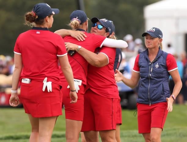 Captain Patty Hurst congratulates Nelly Korda of Team USA and Ally Ewing of Team USA after winning their match during the Foursomes Match on day one...