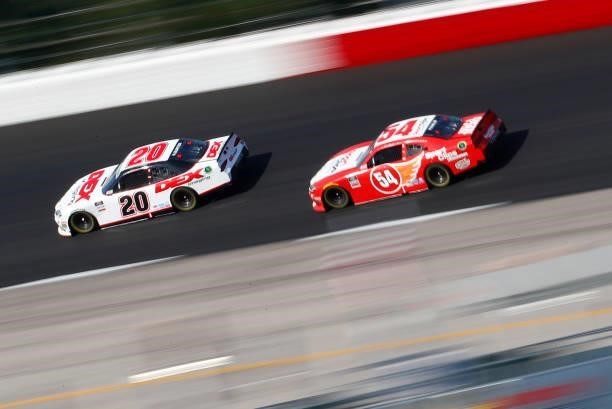 Harrison Burton, driver of the DEX Imaging Toyota, and Denny Hamlin, driver of the SportClips Haircuts Toyota, race during the NASCAR Xfinity Series...