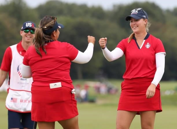 Jennifer Kupcho of Team USA fist bumps Lizette Salas of Team USA on the 18th green after winning their match during the Foursomes Match on day one of...