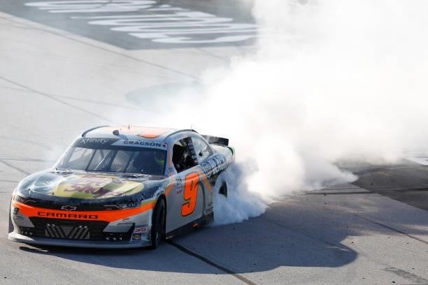Noah Gragson, driver of the Bass Pro Shops/TrueTimber/BRCC Chevrolet, celebrates with a burnout after winning the NASCAR Xfinity Series Sport Clips...