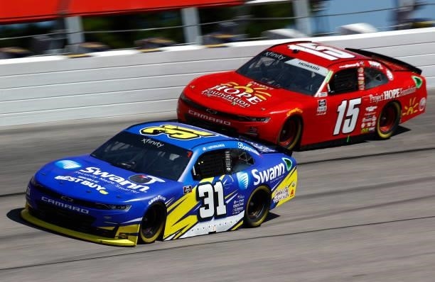Austin Dillon, driver of the Swann Security Chevrolet, and Colby Howard, driver of the Project Hope Foundation Chevrolet, race during the NASCAR...