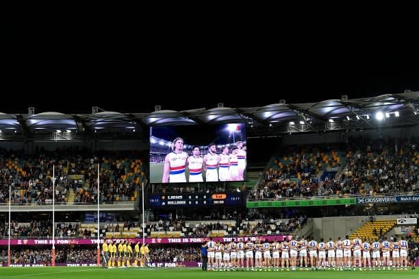 The teams line up for the national anthem ahead of the AFL 1st Semi Final match between the Brisbane Lions and the Western Bulldogs at The Gabba on...